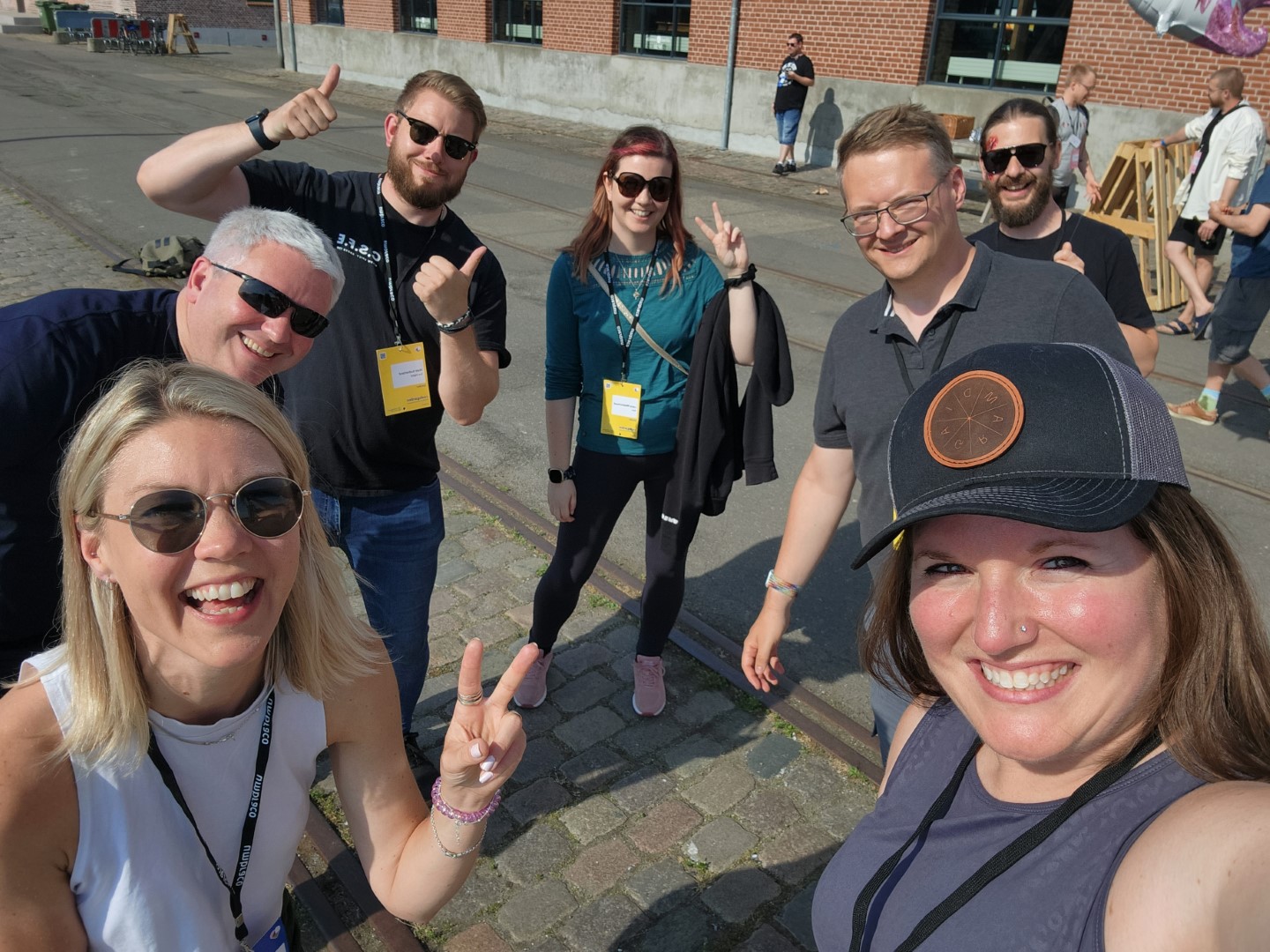 The backoffice community team smiling outdoors at code garden.